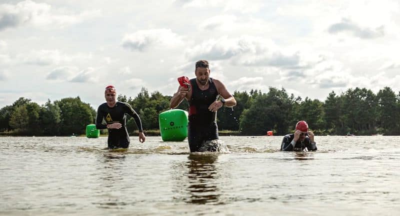 Three swimmers exiting the lake at Hoveringham in Pocklington near York