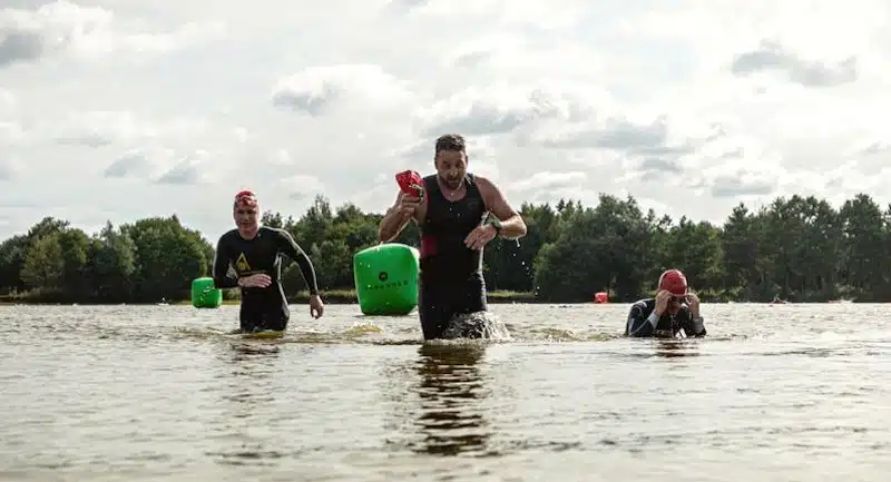 Three swimmers exiting the lake at Hoveringham in Pocklington near York