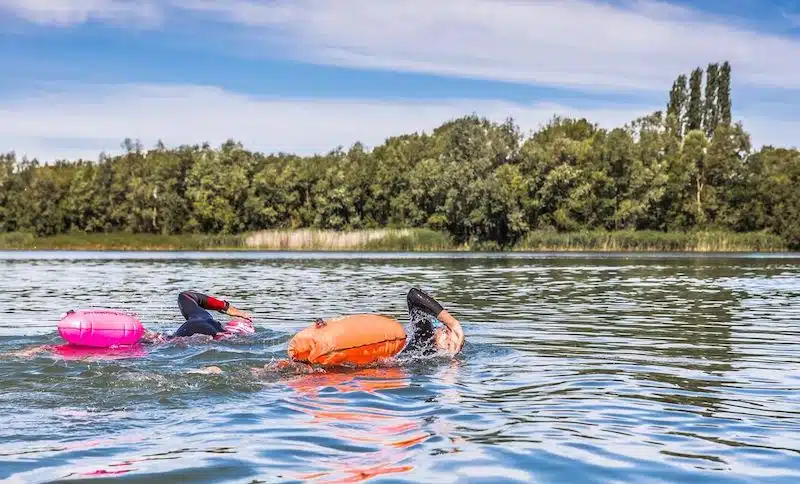 Two people enjoying open water swimming in Caversham Lakes in Reading