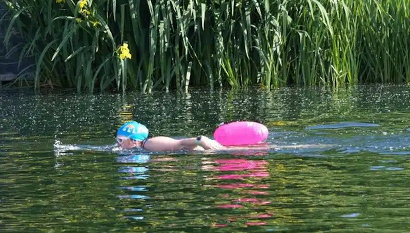 Woman with tow float swimming at Hert Young Mariners Base in Hertfordshire