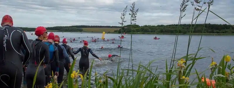 Swimmers entering the lake at QE2 Lake, Woodhorn, Northumberland