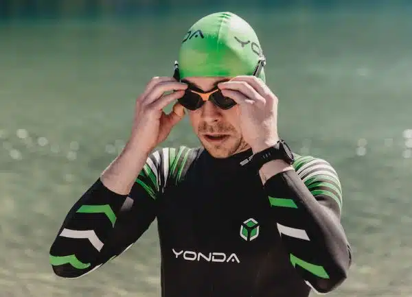Man adjusting swimming goggles before wild swimming