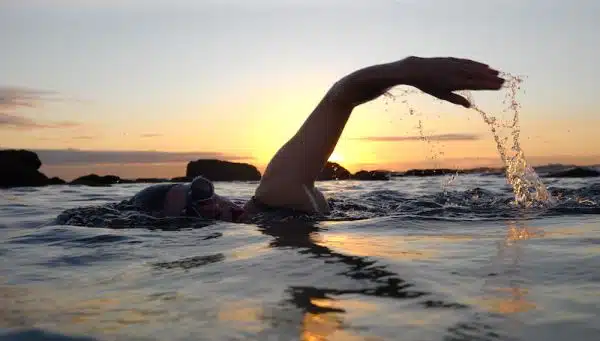 Outdoor swimmer enjoying sunset wild swimming