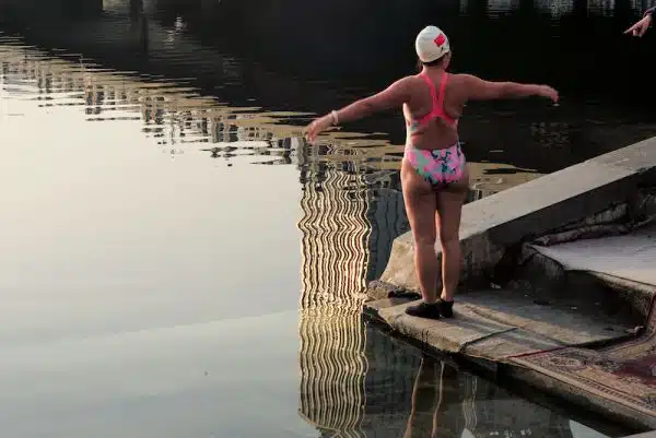 Woman about to swim in a river in a city