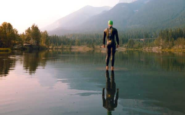 Outdoor swimmer wearing wetsuit and swimming hat